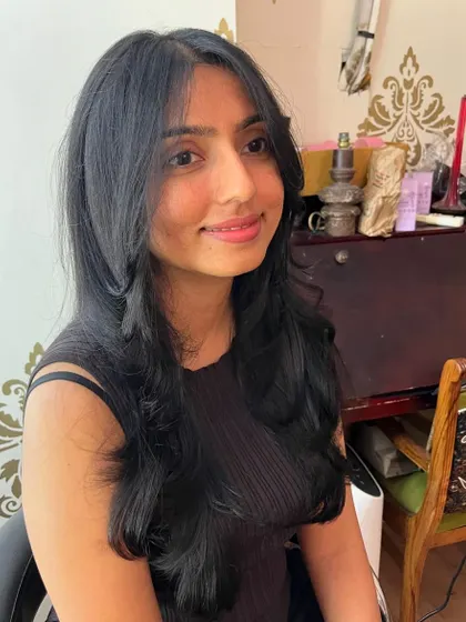Curtain bangs and butterfly layers for Smitha, a popular and flattering style.