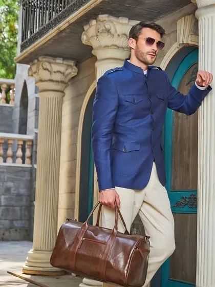 This brighter blue four-pocket Jodhpuri jacket in Irish linen, paired with beige breeches, is stylish, fashionable, and sartorially made for your perfect fit.