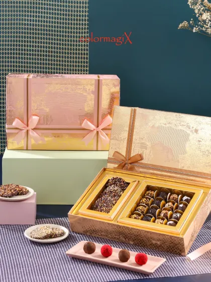 Our luxury chocolate boxes are designed for indulgence. This hamper features a selection of chocolate barks and assorted truffles, presented in a shimmering gold and pink box.