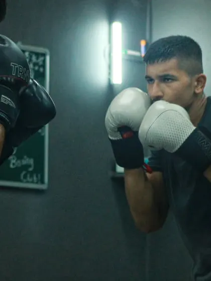 The calm before the storm. A fighter stands ready, focused, in the quiet moments before a drill begins.