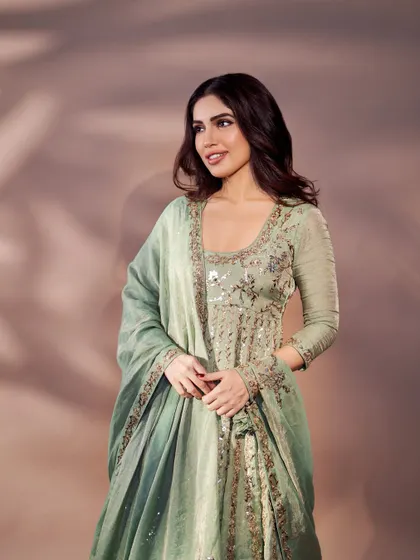 A smiling shot of Bhumi in the mint green suit. This look is all about quiet confidence and grace.