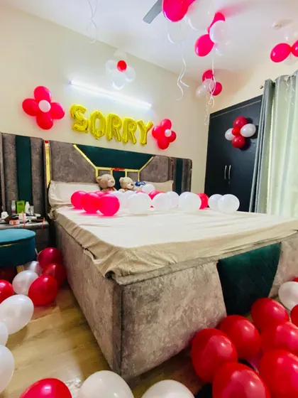 Another angle of the "Sorry" themed room decoration, showing the full bed and floor balloon arrangement.