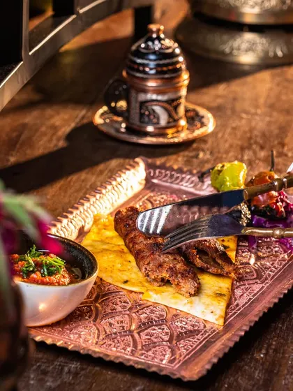 Our grand Adana Kebab is not just a meal, it's an experience. Served on an ornate copper tray, it's a feast for the eyes and the palate, perfect for sharing.