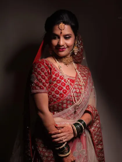 From intricate lehengas to radiant smiles, this bride epitomizes grace and tradition. A beautiful shot of one of our happy clients.