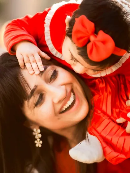 A mother and her little bear enjoying the golden hour glow. This candid shot from an outdoor mommy-and-me session captures the pure happiness and affection in a simple, beautiful moment.