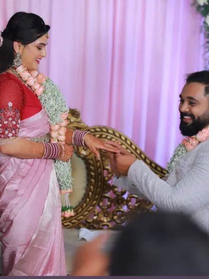 A candid moment from the ring ceremony, with the bride looking lovely in her custom-designed ensemble.