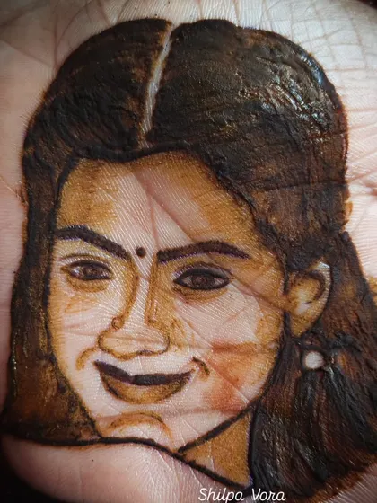 A practice portrait of actress Rashmika Mandanna, focusing on capturing her smile and expression with henna.
