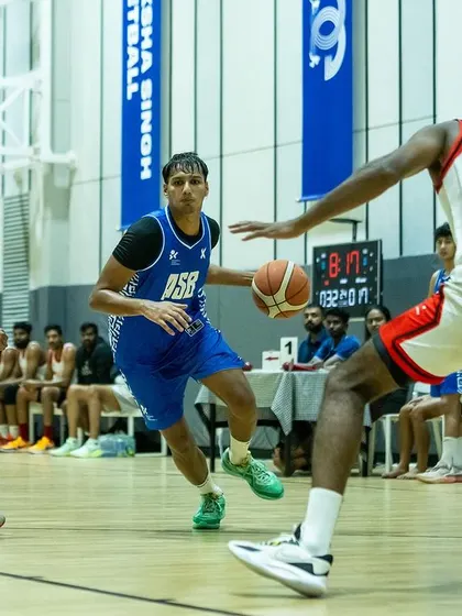 Breaking down the defense. An ASB player navigates a triple-team threat, showcasing ball control under pressure.