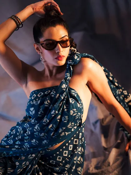 A powerful pose that highlights the unconventional styling of the saree. This image is about breaking rules and creating a memorable fashion moment.