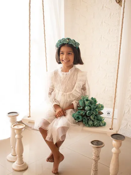 A happy and bright portrait on our classic white studio swing. The simple setup and her joyful smile are a perfect combination.