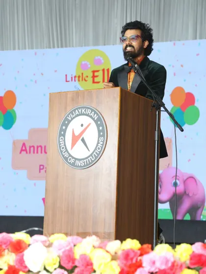 Addressing the audience from the podium at the Little Elly annual day. I can seamlessly switch between high-energy hosting and more formal presentations.
