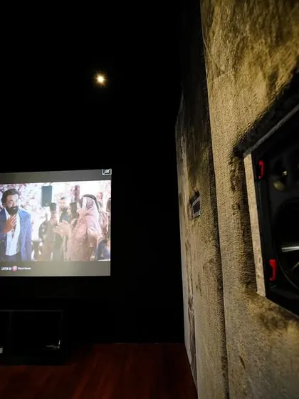 A close-up of an Episode in-wall speaker, set against the textured concrete-finish wall. This demonstrates the blend of raw and refined elements in this unique design.