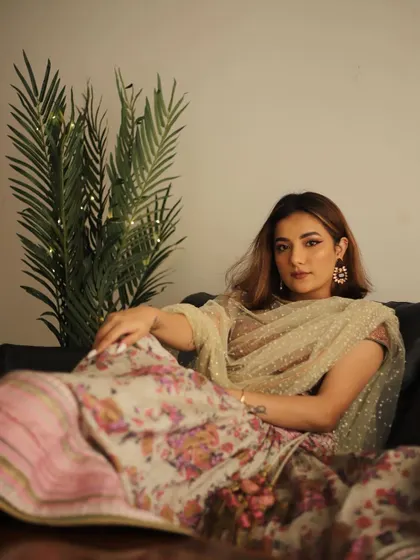 A relaxed and stylish shot of Mrunal Panchal in the floral lehenga.