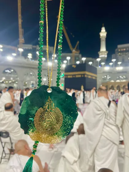 A luxurious car hanging in an emerald green and gold design, featuring Ayat ul Kursi. It's paired with a matching crystal tasbeeh, making it a beautiful spiritual accessory for your vehicle.