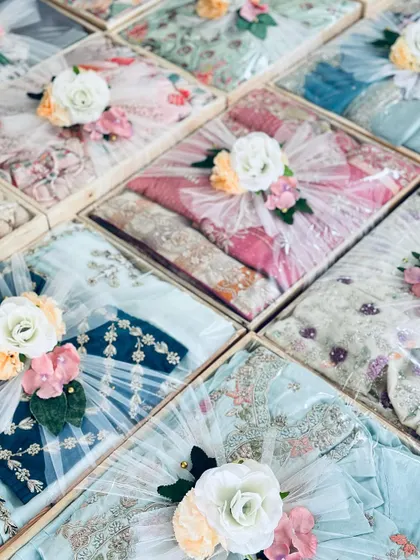 Another perspective of the pastel trousseau collection, showcasing the variety of colors and fabrics, all unified by our signature floral packing style.