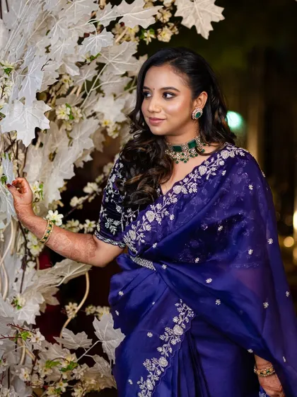 Tejaswini chose this gorgeous embroidered purple saree for her reception. I created a soft smokey eye and styled her hair in romantic waves to complete the look.