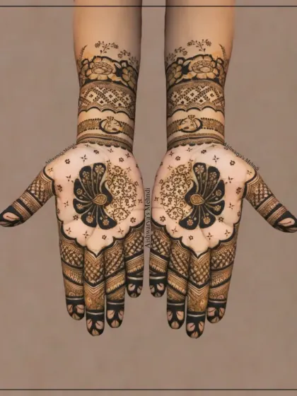A classic bridal design featuring symmetrical peacock motifs on the palms. The detailed patterns on the fingers and wrists make this a timeless choice for any bride.
