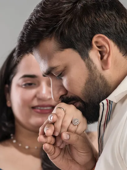 A gentleman's kiss on his partner's hand. This classic, romantic gesture is captured beautifully, showing love and respect.