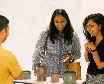 Visitors admiring the work at our student exhibit. The support from the community means the world to us and our artists.