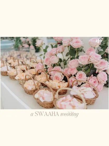 A collection of images from a dreamy Dubai wedding, featuring pastel rose floral arrangements, from the main arch to the small baskets of petals for guests.