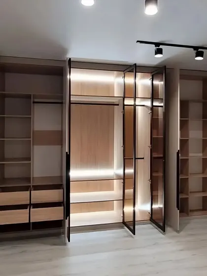With the doors open, you can see the full extent of the organization inside this wardrobe. It features a mix of hanging space, drawers, and shelves, all designed to maximize storage and accessibility.