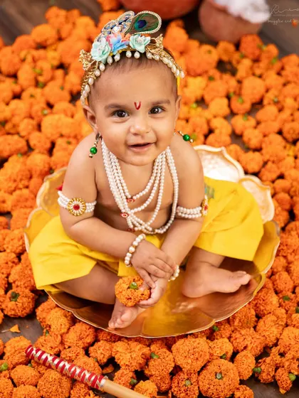 Our little Krishna sitting in a sea of marigolds. The vibrant colors and textures in my Janmashtami setups make for such joyful photos.