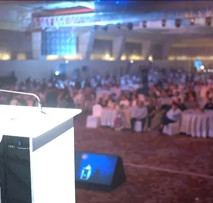 A view from my perspective on stage, looking out at a large, attentive audience during a corporate gala.