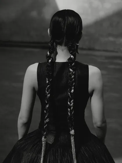 A black and white shot from the Ani Clothing campaign, focusing on the intricate braided hairstyle.