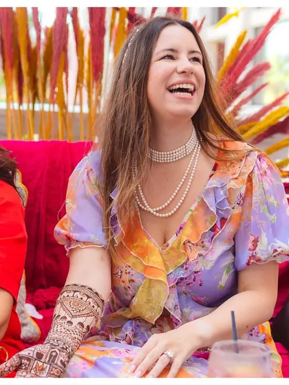 A bride's radiant smile during her Mehendi ceremony, a moment of pure joy as she embraces a beautiful tradition.