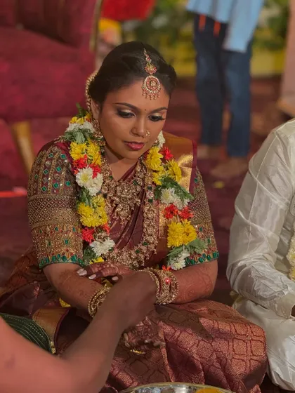 A candid shot of my bride Prithivi during her wedding rituals in Trichy. Her makeup is designed to be long-lasting and photo-ready, even during the most emotional moments of the ceremony.