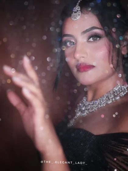 A dreamy, artistic shot of the black shimmer lehenga, with a bokeh effect that adds a touch of magic. This shows the outfit's potential for creative photoshoots.