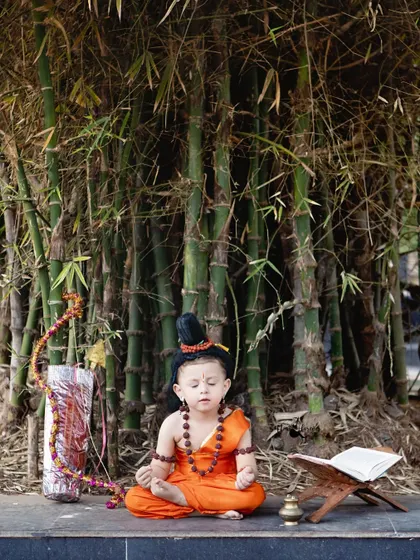 Finding peace and serenity. This shot captures a meditative moment during our outdoor Lord Ram themed birthday shoot, set against a backdrop of bamboo.