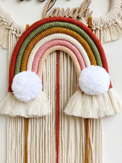 A close-up of the rainbow on the "Live, Love, Laugh" wall hanging. The earthy, warm colors were chosen specifically by the client to match their home decor.
