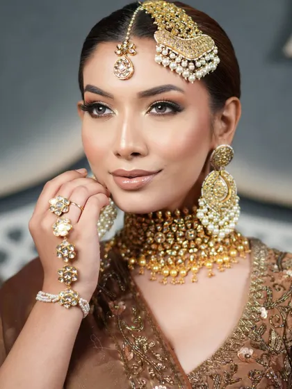 This close-up shows the flawless makeup and the clean lines of the hairstyle, creating a look of pure, understated elegance.