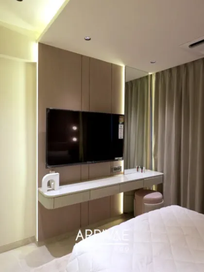 A great example of a multi-functional bedroom, where the TV unit is combined with a sleek, floating dressing table. This is a perfect space-saving solution for compact rooms.