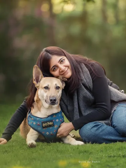 A beautiful, tender portrait of a woman and her dog. The soft lighting and gentle embrace create a feeling of peace and deep affection.