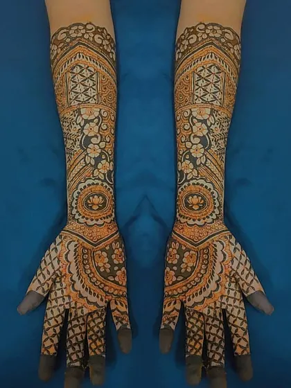 A symmetrical bridal design that extends up both forearms. I used a mix of geometric grids, mandalas, and floral elements to create this detailed and balanced artwork.