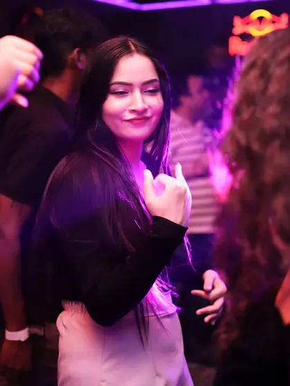 A candid shot of a guest feeling the music on the dance floor. My focus is always on creating a space where people can let loose and have fun.