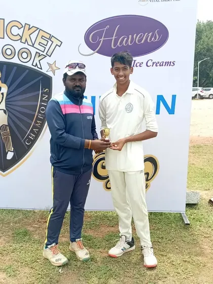 Another one of our talented cricketers is recognized for his performance, receiving a trophy from a coach at a tournament awards ceremony.