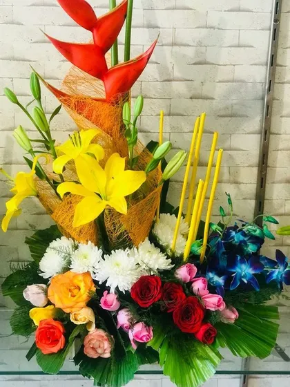 If you want a custom design, I can create it for you. This is a unique, artistic arrangement with mixed flowers like heliconia, lilies, roses, and orchids for a truly special occasion.