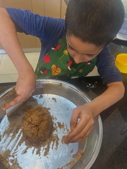 Kai carefully forming the dough into a ball. Baking is a fantastic, real-world way to learn about measurement, sequence, and transformation.