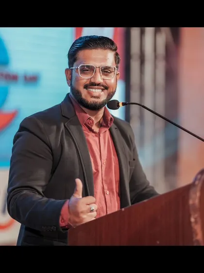 A thumbs-up from the podium during a corporate foundation day. It's my way of signaling that everything is going great and we're all having a good time.
