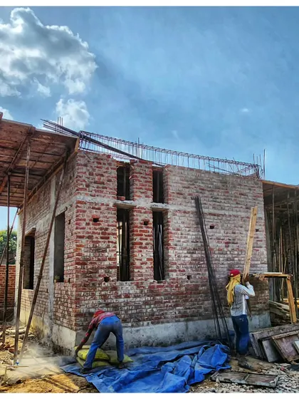 A modern office space taking shape with brickwork. This image captures the raw beauty of the construction process against a dramatic sky.