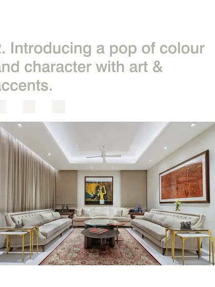 Introducing a pop of color and character with art and accents can personalize a space. In this formal living room, large paintings add personality to an otherwise neutral and calming palette.