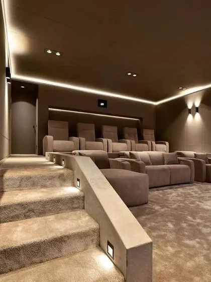 A view of the tiered entry steps, carpeted for comfort and safety. The lighting is integrated into the steps, guiding the way without being distracting.