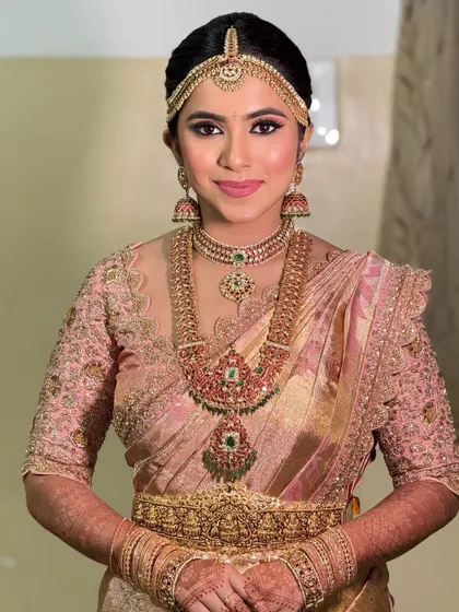 The bride's look without the veil, showcasing her beautiful hair and the intricate details of her jewelry and blouse.