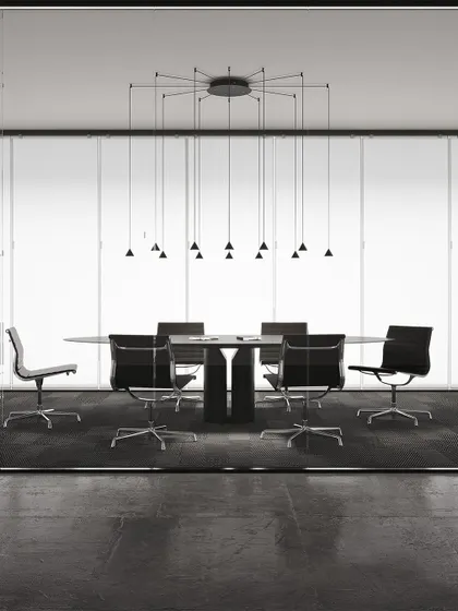 A large, spider-like configuration of the Filomena system, providing focused light over a long conference table. This is a perfect example of a highly functional and aesthetically minimal lighting solution for corporate spaces.