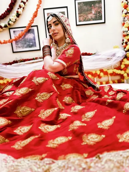 A full bridal look, complete with a dupatta veil. This red lehenga is one of our most popular traditional rentals.