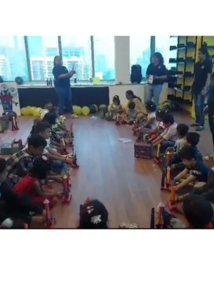 A wide view of our rocket-building station at a corporate founder's day. Our instructors guide the children through the process, ensuring everyone succeeds in building their launcher.