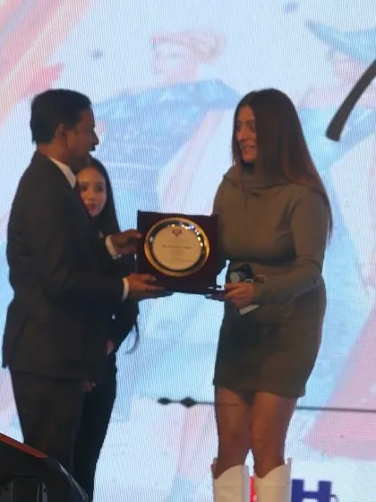 A guest of honor receives a plaque of appreciation during the Memorabilia awards ceremony.